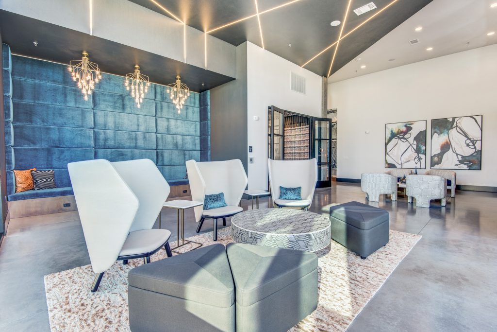 Lobby seating area with two large comfy chairs and ottomans